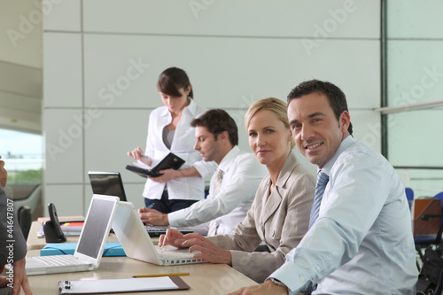 Photo: Colleagues working at laptop computers in an office environment Colleagues working at laptop computers in an office environment