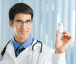 Happy doctor showing bottle of drugs