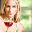 Young woman with glass of red wine