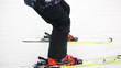 close-up of skiers legs with skis that ride on snow