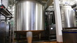 huge steel tank of fresh milk, panorama from bottom up
