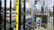 industrial robot takes sheet MDF, puts it on packaging bottles