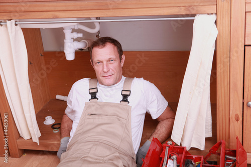 Photo: Plumber repairing a sink Plumber repairing a sink
