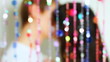 hugs and kisses couple behind blind cords from of beads