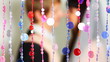hugs and kisses couple behind blind cords from of beads