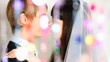 hugs and kisses couple behind blind cords from of beads