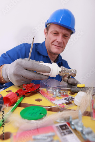 Photo: Plumber with a thermostatic radiator controller Plumber with a thermostatic radiator controller