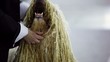 Owner pats dog of komondor breed with curls
