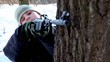 Young boy rises air rifle and shoots in park