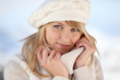 Blond woman wearing winter jumper and hat