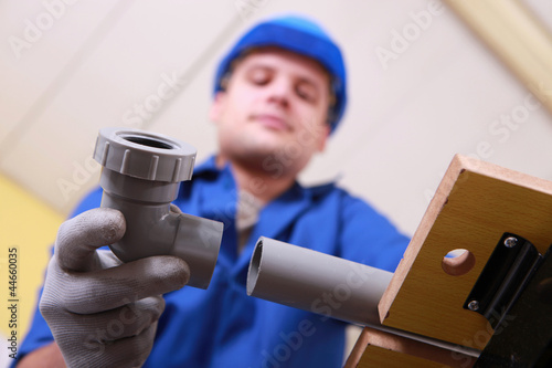 Photo: Plumber joining plastic pipes Plumber joining plastic pipes