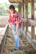 Woman cleaning animal enclosure