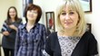 woman working in beauty salon affably looks and smiles