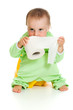 Child on potty play with toilet paper