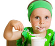 girl eats with a spoon dairy product.