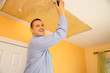 Handyman sanding ceiling