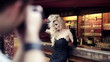 Beautiful woman on photo session in bar, steadicam shot