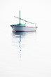 Lonely fishing boat on very calm sea