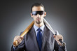 Angry businessman with bat on white