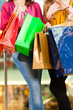 Two women shopping with bags in mall
