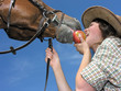 young cowgirl and her friend eating an apple