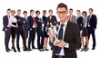 businss man holding a trophy in fron of his team
