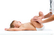 doctor massaging or doing gymnastics baby girl