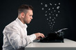 Photo: Young man writing with an old typewriter. Conceptual image Young man writing with an old typewriter. Conceptual image