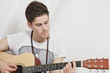 Young Caucasian man playing guitar