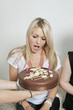 Friends surprising young woman with birthday cake