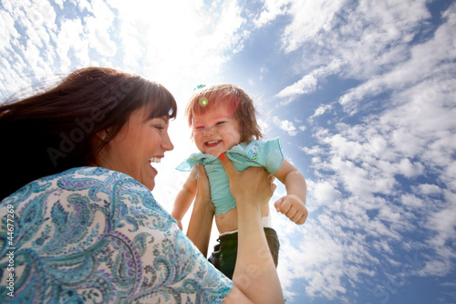 Photo: Mother Holding Daughter in Air Mother Holding Daughter in Air