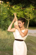 Greek girl with vase in the summer garden