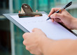 Foto: Businessman Holding A Clipboard And Writing Businessman Holding A Clipboard And Writing