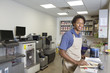 Photo: Portrait of an African American male at paint section in super market Portrait of an African American male at paint section in super market