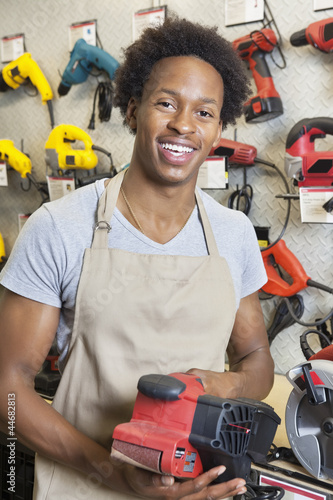 Photo: Portrait of an African American male store clerk holding electronic tool Portrait of an African American male store clerk holding electronic tool