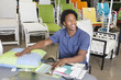 Photo: Male African American salesperson working in garden furniture store Male African American salesperson working in garden furniture store