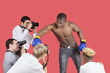Photo: Paparazzi taking photographs of male boxer over red background Paparazzi taking photographs of male boxer over red background