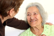 Careing for a elderly woman lying in bed