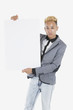 Portrait of a young man holding blank cardboard over gray background