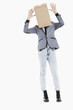 Photo: Young boy with box covered over his face and hands raised over gray background Young boy with box covered over his face and hands raised over gray background