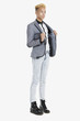Teenage boy in smart casuals over gray background