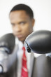 Photo: Businessman wearing boxing gloves with focus on gloves Businessman wearing boxing gloves with focus on gloves