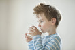 Side view of a young boy drinking milk