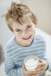 Portrait of happy young boy drinking milk