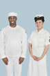 Foto: Portrait of happy female US Navy officer with male sailor over light blue background Portrait of happy female US Navy officer with male sailor over light blue background