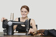 Photo: Portrait of young female tailor stitching cloth on sewing machine over colored background Portrait of young female tailor stitching cloth on sewing machine over colored background