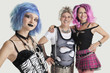 Photo: Group portrait of young female punk with senior couple standing in background Group portrait of young female punk with senior couple standing in background