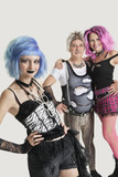 Photo: Group portrait of young female punk with senior couple standing in background Group portrait of young female punk with senior couple standing in background