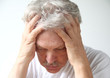 senior man holds his head in despair