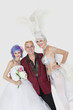 Photo: Portrait of man with senior showgirl and daughter in wedding dress over gray background Portrait of man with senior showgirl and daughter in wedding dress over gray background
